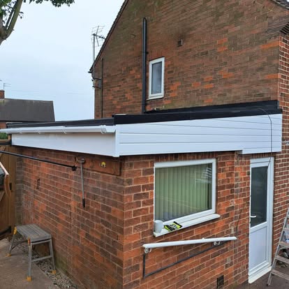 Completed EPDM and white fascia ladder visible