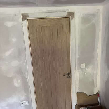 Oak internal door fitted in plastered room