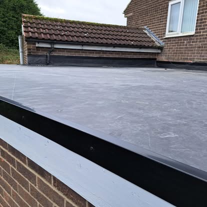 Large EPDM flat roof with brick parapet