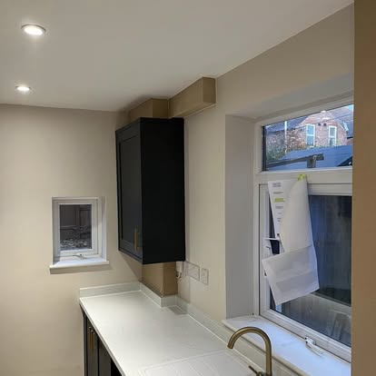 Modern kitchen dark cabinets being installed