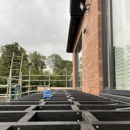 Composite balcony decking frame next to glazing