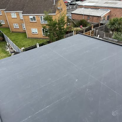 Large EPDM flat roof aerial urban setting