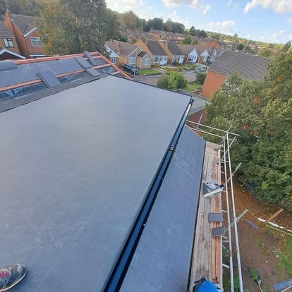 Large EPDM flat roof with scaffolding suburban