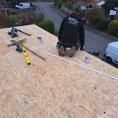 Roofer laying OSB on large flat roof