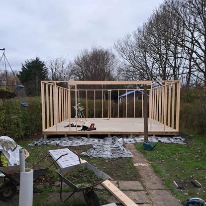 Garden room timber frame being built in garden