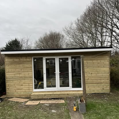 Completed garden room with white uPVC French doors