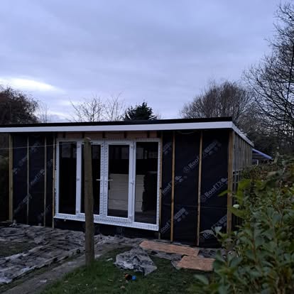 Garden room cladding with black membrane wrap