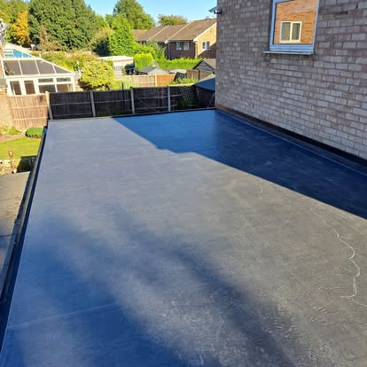 Completed EPDM flat roof suburban garden view