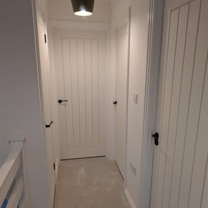 Hallway with three painted white timber doors