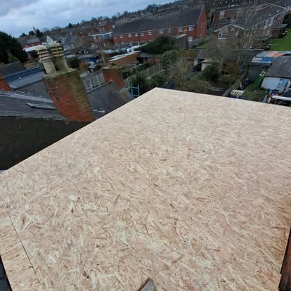 OSB boards on flat roof urban terrace chimneys