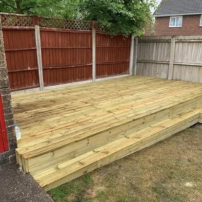 Ground-level timber decking with step down to garden