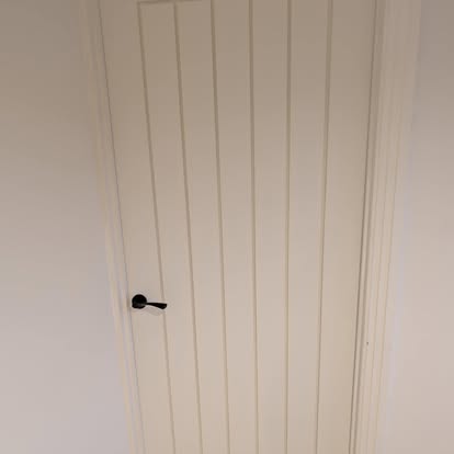 White vertical panel interior door with black handle fitted