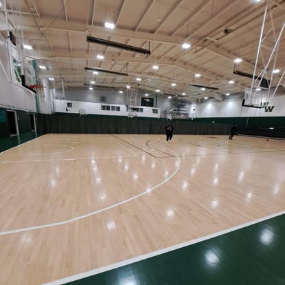 Commercial basketball court interior with new maple floor