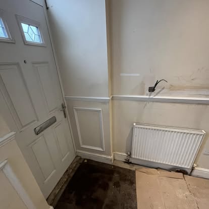 Hallway with front door and panelling before work