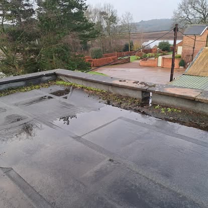Flat roof with standing water rural setting