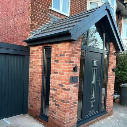 Brick porch extension with dark grey pitched canopy