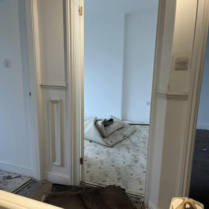 Interior hallway with tall panelled doors during renovation