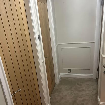 Oak slatted door fitted in hallway with dado panelling