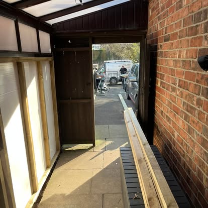 Lean-to interior with polycarbonate roof and worker outside