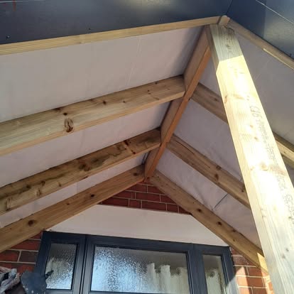 Porch interior apex roof with timber rafters and grey fascia