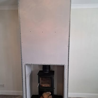 Plasterboard chimney breast surrounding wood burner stove