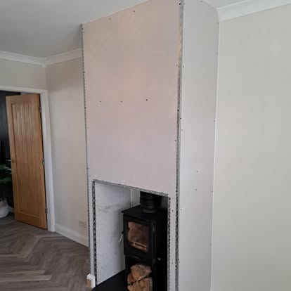 Plasterboard chimney breast surround around wood burner