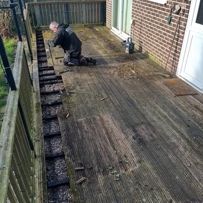 New composite decking laid with timber pergola being built