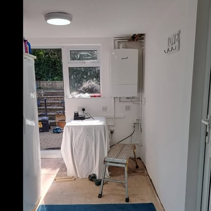Utility room with boiler cupboard door open