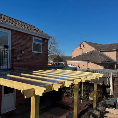 Timber pergola frame nearly complete with rafters visible