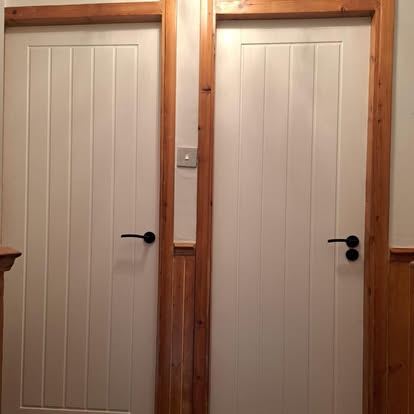 Two white panelled interior doors with pine frame