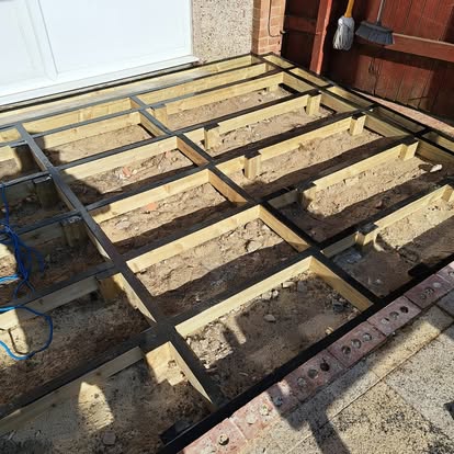 Timber decking subframe being built next to garage door