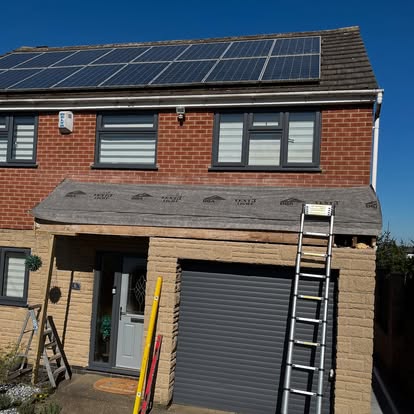 Old dark felt canopy being replaced on semi-detached