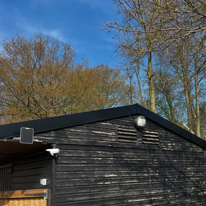 Black corrugated metal barn roof completed exterior