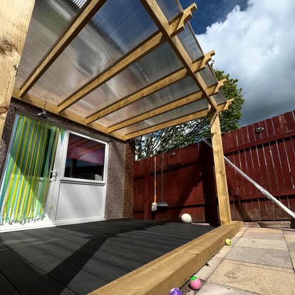 Dark composite decking with polycarbonate pergola completed