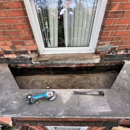 Old membrane being stripped from Victorian bay window roof