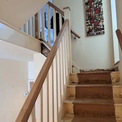 Staircase renovation exposed brick wall and stained glass window