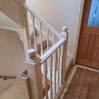 White staircase with ball newel posts and spindles