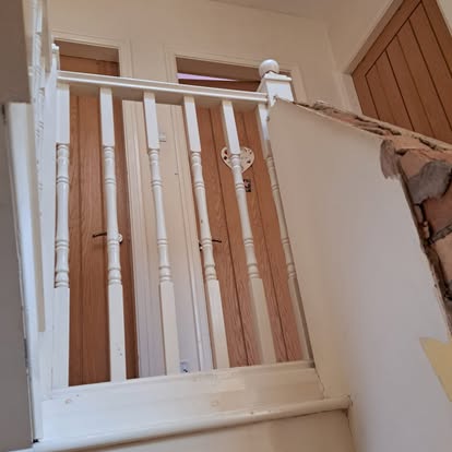 White painted staircase with turned spindles