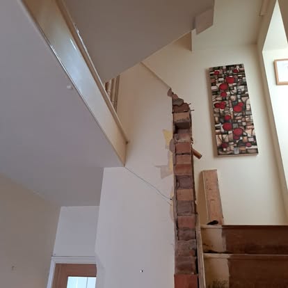 Exposed brick chimney breast during stair renovation'ot-13
