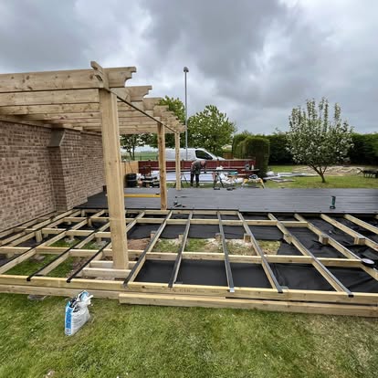 Composite deck joists with pergola frame being built
