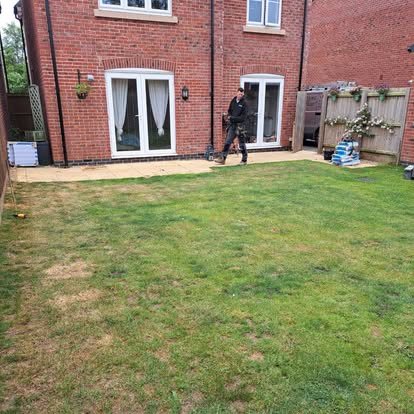 Worker installing decking at new build house