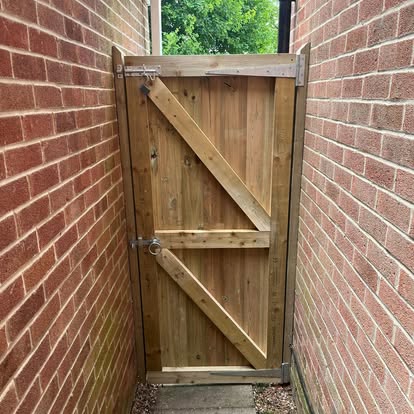 Old weathered timber side gate before replacement