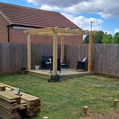 Timber deck with pergola and black rattan furniture
