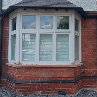 New UPVC bay window installed on red brick terrace