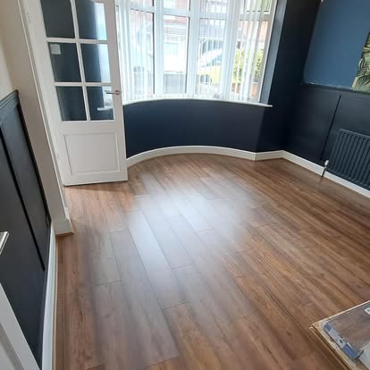 Completed wood-effect LVT floor in bay window room