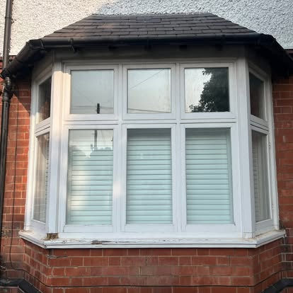 New UPVC bay window installed on red brick terrace