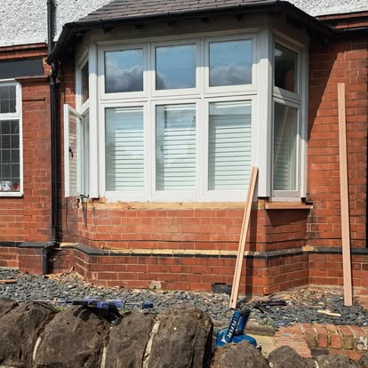 Bay window installation in progress with tools on ground