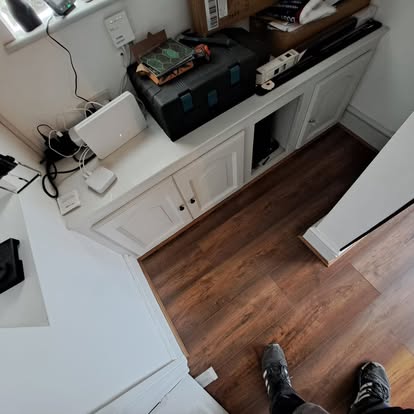 White shaker cabinets with LVT flooring laid overhead