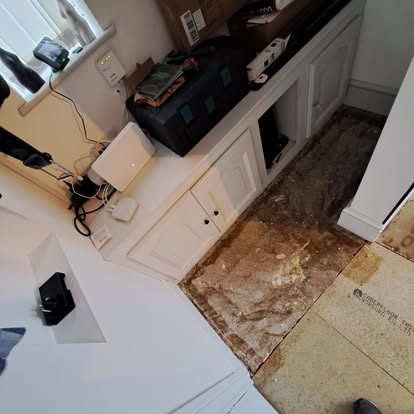 White shaker cabinets with floor tiles being stripped