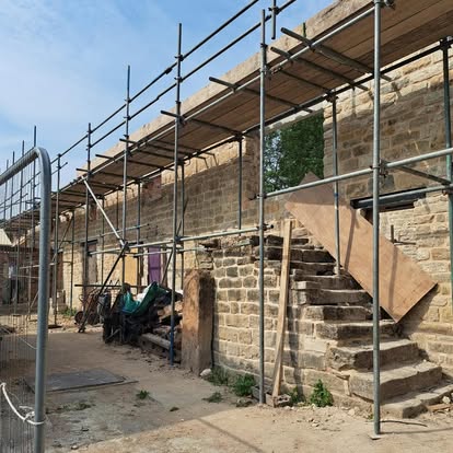 Historic stone building with scaffolding for roof repair